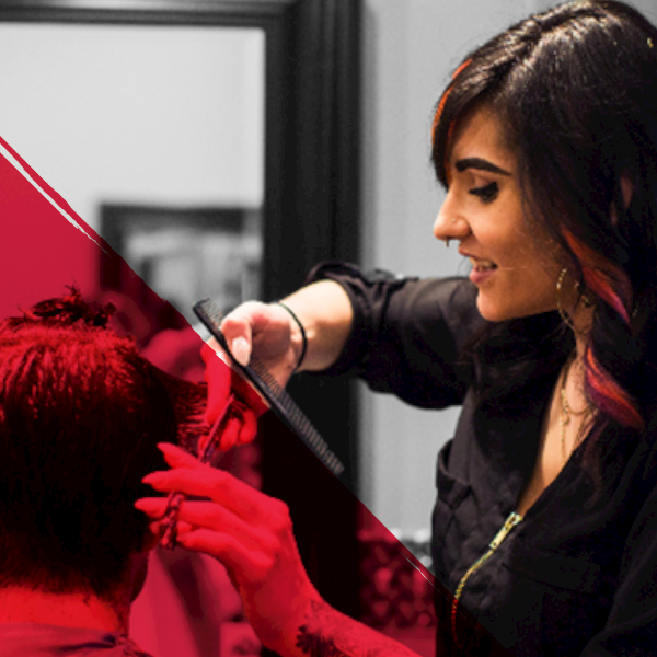Woman hairstylist cutting a mans hair